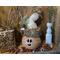 This shows a Christmas gourd decoration. It is made to look like an elf, with a custom sherpa hat and winter decorations.